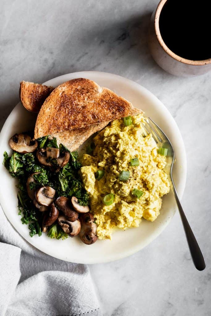 tofu scramble with vegetables and toast on a plate