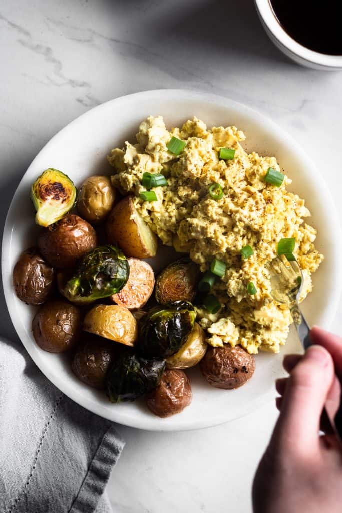 tofu scramble on plate with potatoes