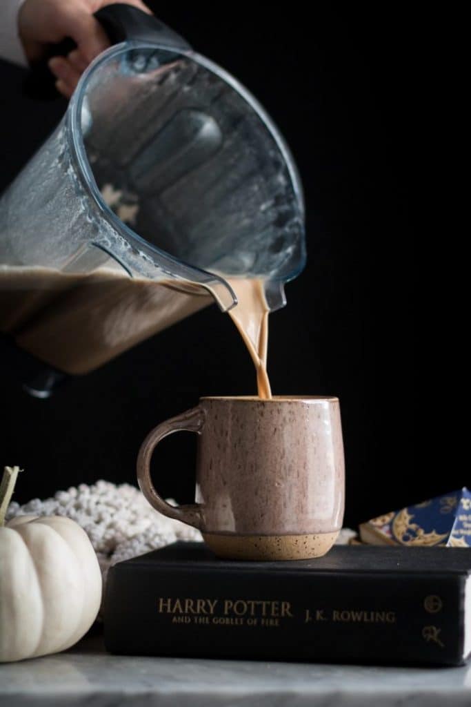latte being poured into a mug
