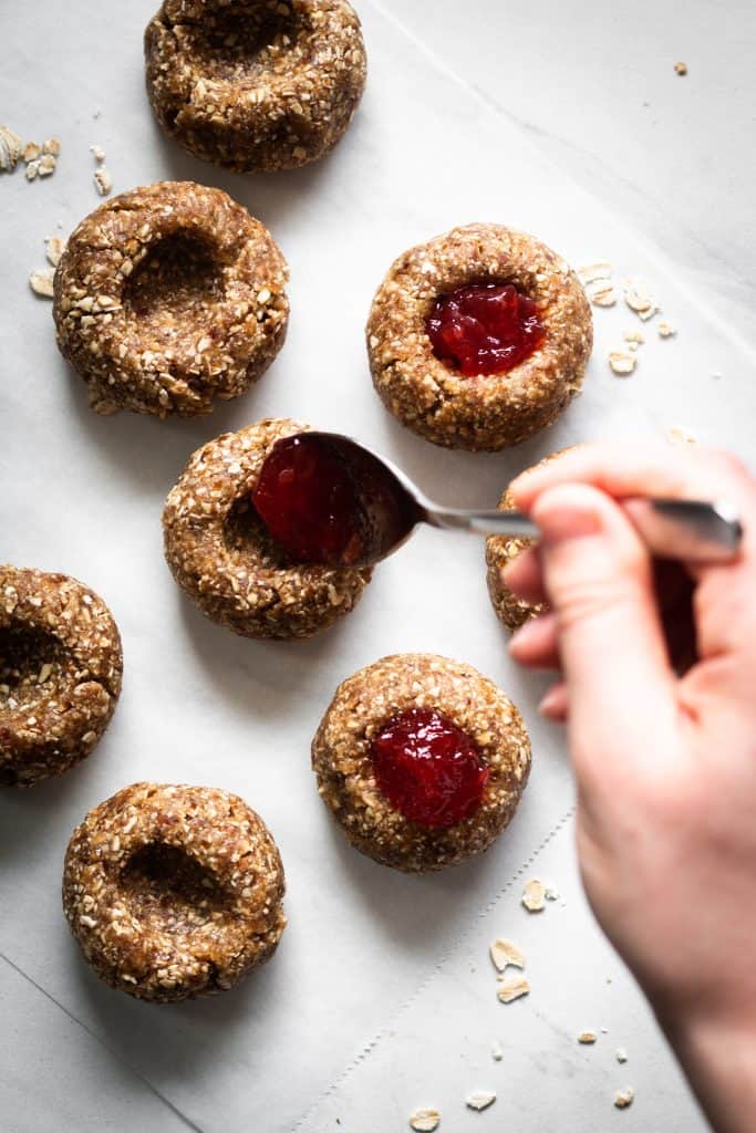 adding jam in thumbprint cookies