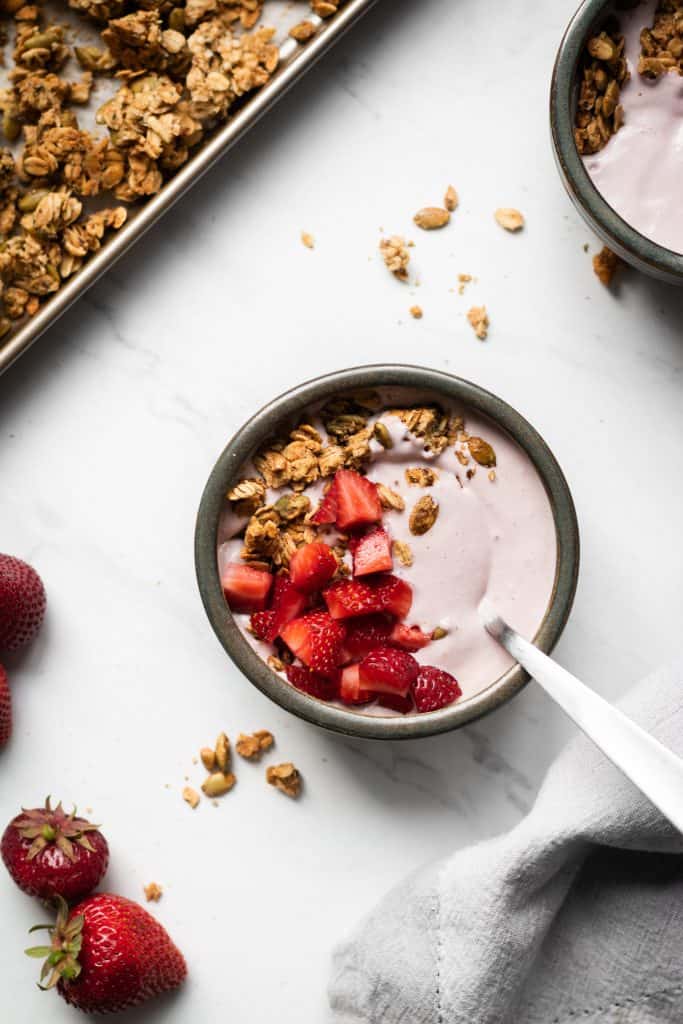 yogurt in a bowl with granola and berries
