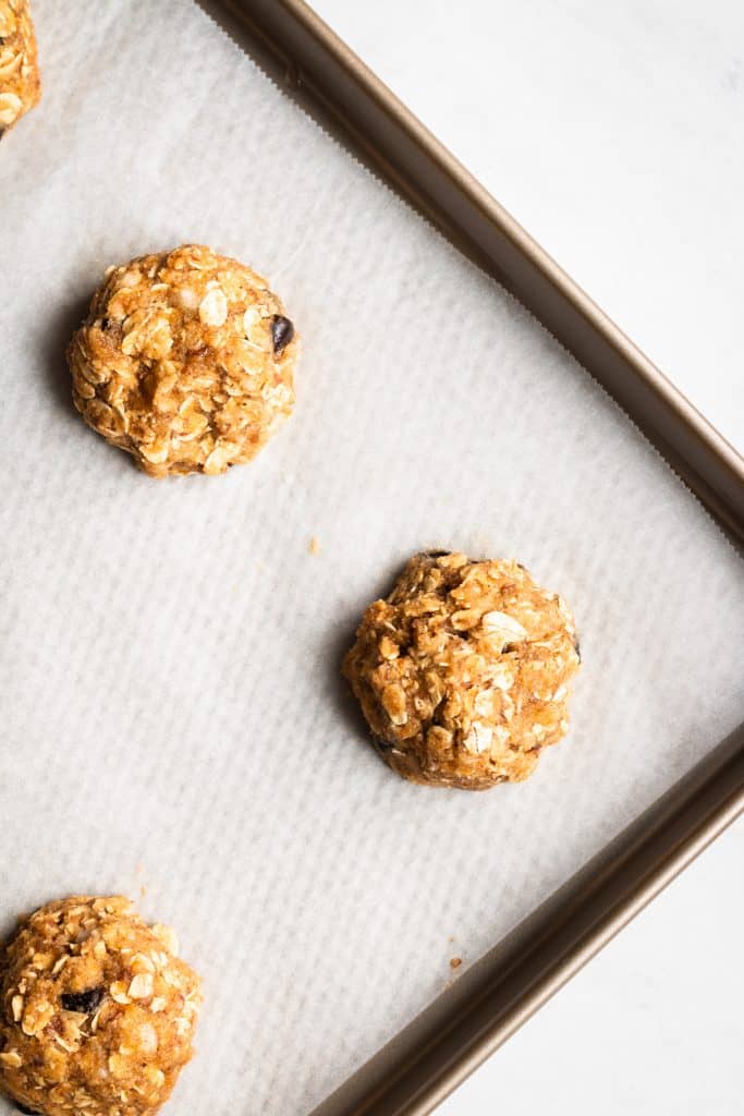 unbaked pumpkin chocolate chip cookies on a baking sheet