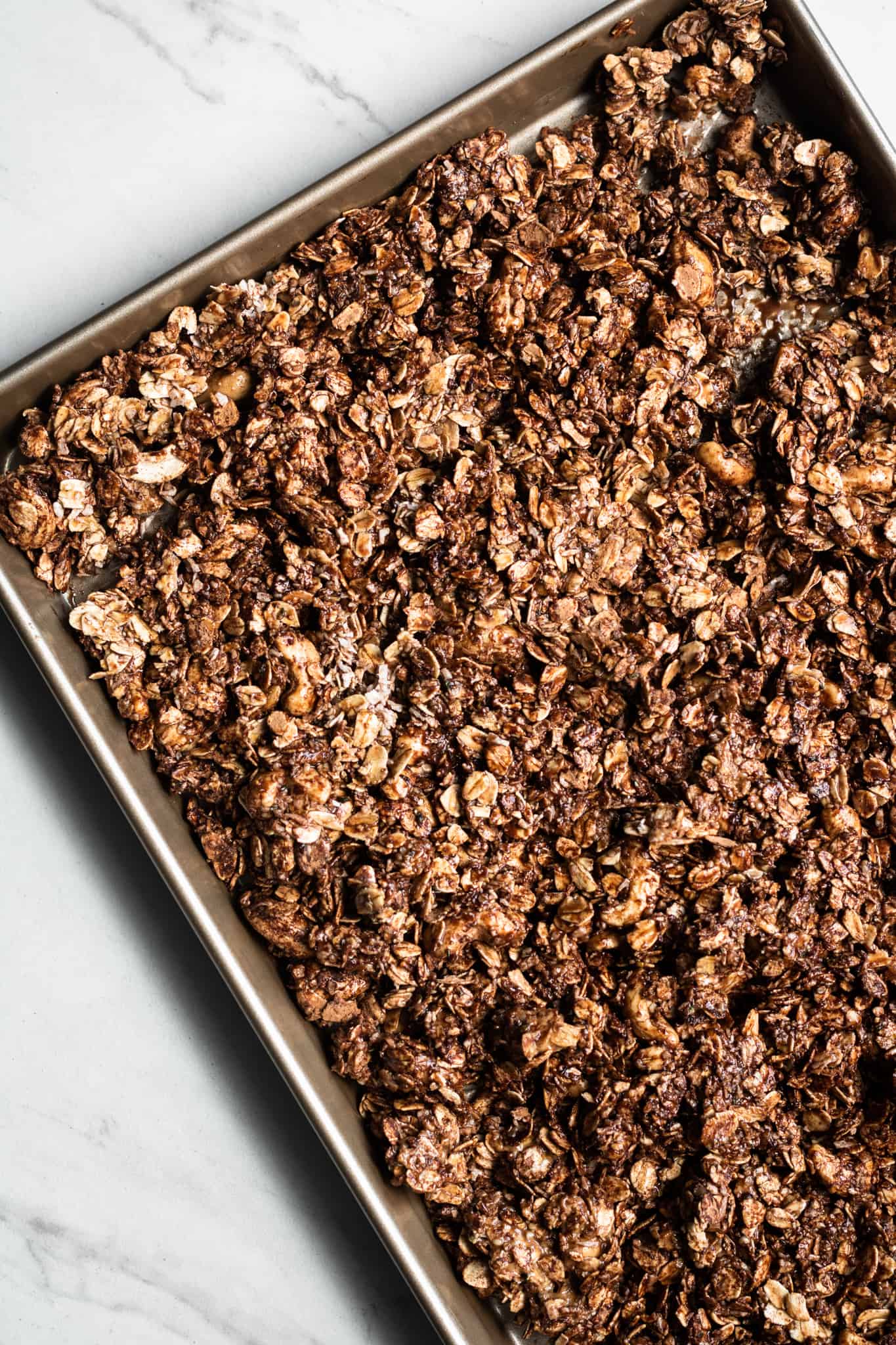granola mixture unbaked on a baking sheet