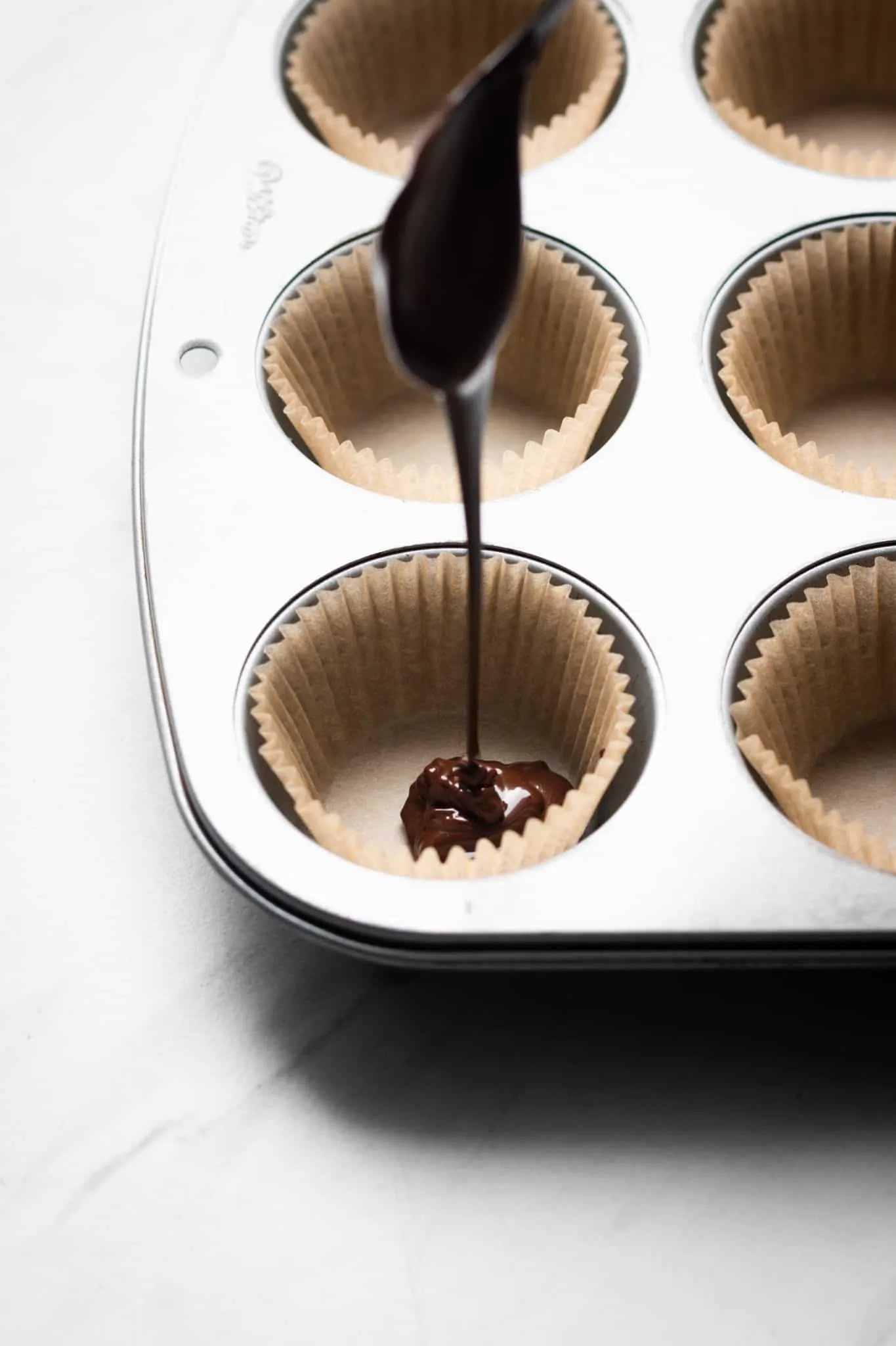 chocolate poured into muffin liners