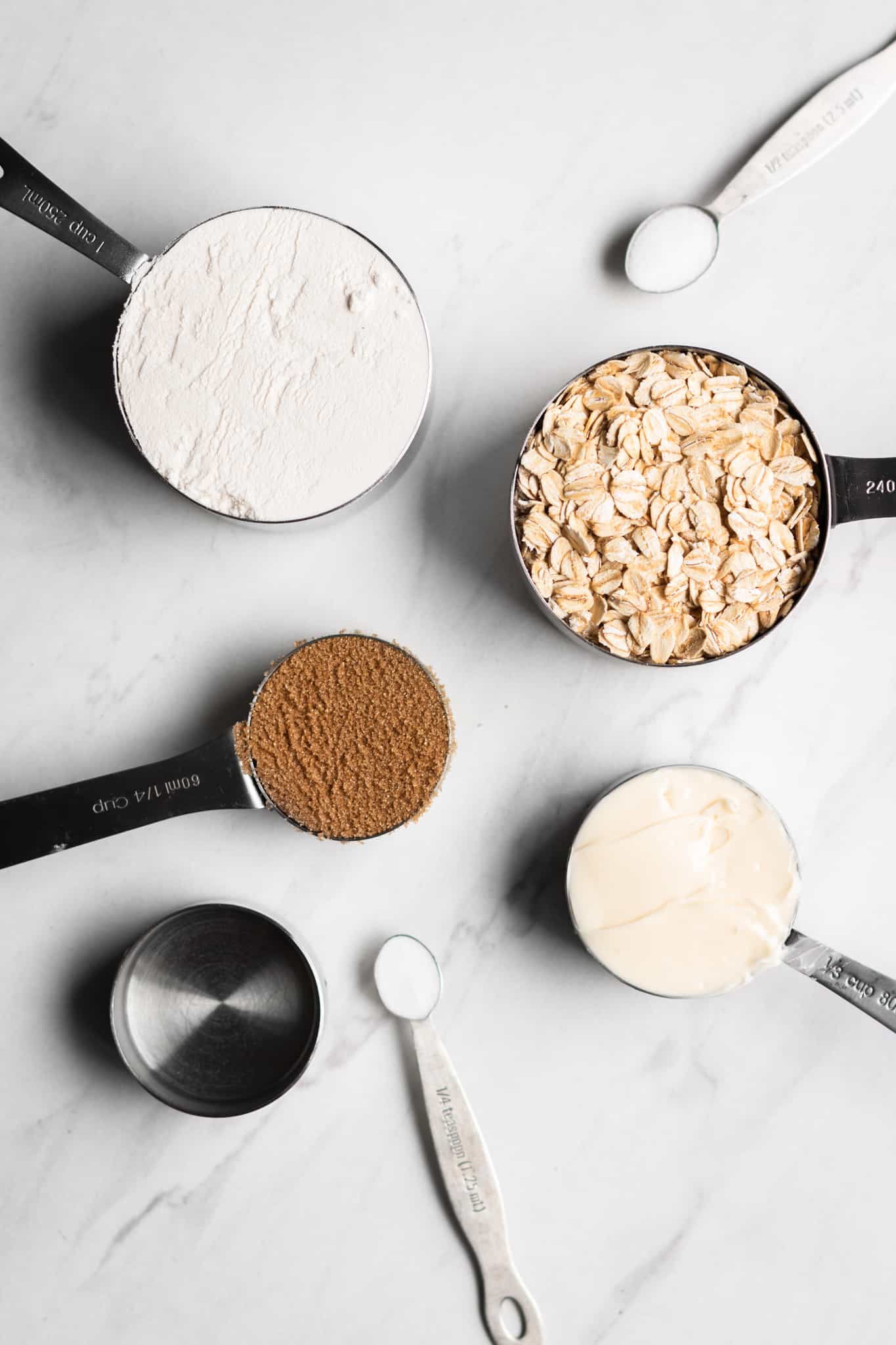 oats, flour, sugar and butter in measuring cups